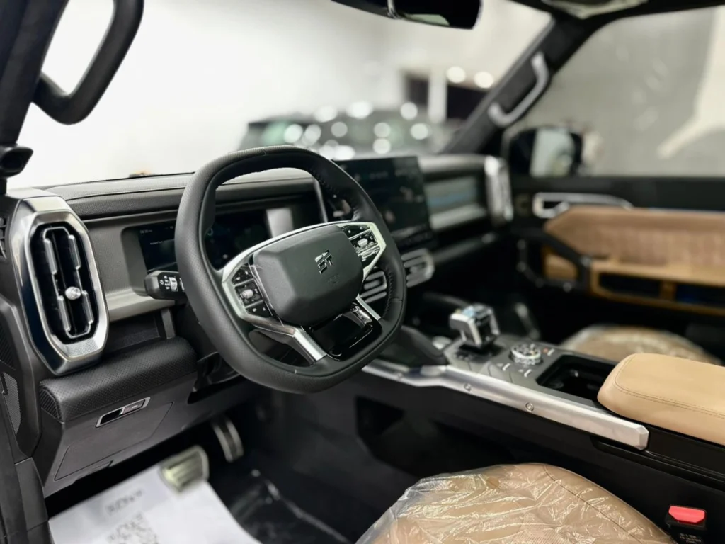 Driver side of the Jetour T2 2025 showing the steering wheel, instrument display and console controls